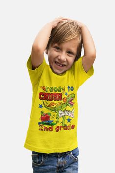 * Get your little one ready to conquer second grade in style with our Boys T-Shirts Ready To Crush Second Grade! Featuring a fierce dinosaur design, this short sleeve t-shirt is perfect for back to school. With its comfortable fit and eye-catching design, your child will feel confident and ready to take on the school year. Shop now and make a statement with this must-have back to school essential! *  * Brand: Hanes * Fabric weight: 6.1 oz (heavyweight) * Material: 100% comfort soft cotton (Heath Fun Short Sleeve T-shirt With Dinosaur Print, Fun Short Sleeve Dinosaur Print T-shirt, Fun Short Sleeve Tops With Dinosaur Print, Back To School T-shirt With Funny Print, Fun Short Sleeve Tops For Daycare, Playful Short Sleeve Tops For Daycare, Fun Summer T-shirt With Dinosaur Print, Funny Short Sleeve T-shirt For Back To School, Funny Dinosaur Print Short Sleeve T-shirt