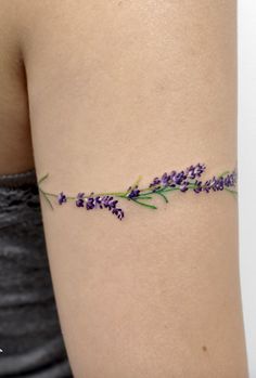 a woman's arm with lavender flowers on it