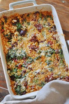 a casserole dish filled with vegetables and cheese