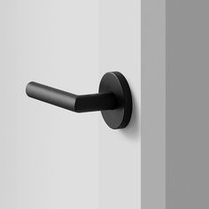 a black handle on a white door