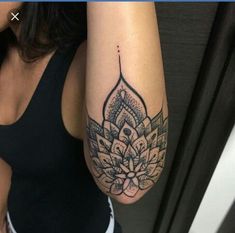 a woman's arm with a tattoo on it and an image of a flower