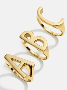 Orders placed between 11/27 - 12/4 will ship between 12/26 - 1/2/25.Add a signature touch to your ordinary ring stack with the 18K Gold East West Initial Ring — featuring the initial of your choice, turned sideways for an unexpected twist. Crafted out of 18K gold plated sterling silver, this ring will become a long-lasting everyday essential for years of wearing. Rings That Dont Tarnish, Designer Ring Stack, Gold Engagement Ring Stack, Word Rings, Jewelry Goals, Auntie Vibes, Simple Gold Jewelry, M Ring, C Ring