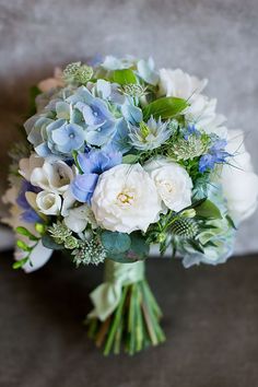 a bridal bouquet with blue and white flowers