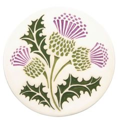 a white plate with green and purple designs on it