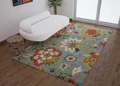 a living room with a couch and rug on the floor