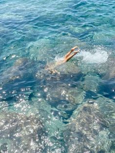 a person swimming in the ocean with clear blue water