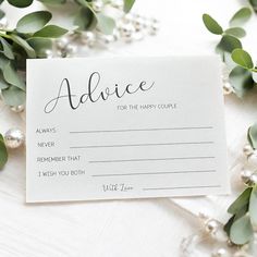 a card with the words advice for the happy couple on it next to greenery