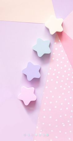 three little stars are on a pink and blue background