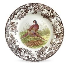 a plate with two birds painted on the front and back of it's sides