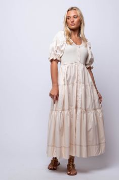 Simple, elegant and effortlessly stylish, the Primrose Midi Dress is the perfect addition to your wardrobe. With its linen look fabric, puff sleeves, and button up design, this dress exudes a casual yet chic charm. Its midi length is versatile and flatters all body types, making it a must-have for any fashion-forward individual. Hand Wash 100% Cotton Import Fit Guide: Hannah is 5ft 5 inches, Bust 32”, Waist 25”, Hips 29” Model is wearing a size small True to size *Available at our Envy Location Feminine Beige Puff Sleeve Midi Dress, Chic Midi-length Puff Sleeve Dress With Button Closure, Feminine Daywear Maxi Dress With Puff Sleeves, Chic Puff Sleeve Midi Dress With Button Closure, Cream Linen Midi Dress For Day Out, Cotton Puff Sleeve Maxi Dress For Brunch, Cotton Maxi Dress With Puff Sleeves For Brunch, Beige Midi Linen Dress For Day Out, Beige Midi Length Puff Sleeve Dress For Brunch