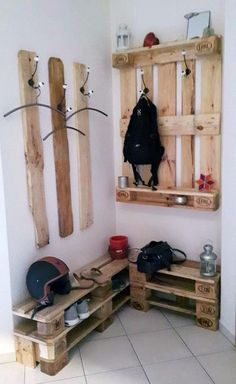 a room with some wooden pallets on the wall and various items hanging from it