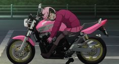 a person riding on the back of a pink motorcycle