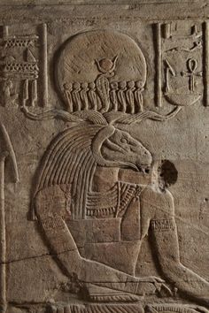 an egyptian relief depicting the god and goddess