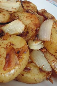 potatoes and onions on a white plate with seasoning