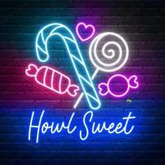 a neon sign that says houli sweet with candy canes and heart shaped candies