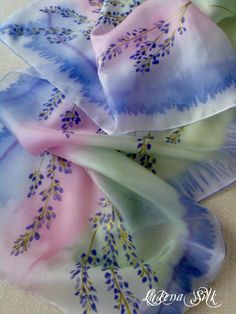 three silk scarves with purple and blue flowers on them