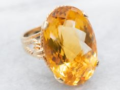 "Sleek styling and modern features, this smooth yellow gold ring is sure to impress. This ring features clean lines and nice proportions, and the yellow gold really accents the stunning golden yellow oval cut citrine dazzling in the center. The rope detail on the band adds uniqueness without taking away from the citrine gemstone. Metal: 14K Yellow Gold Gem: Citrine totaling 25.30 Carats Gem Measurements: 24.6 x 16.2 mm, Oval Ring Size: 6.5 Marks: \"14K\" Stamped on the inside band To view a video of this piece check out the link below: https://vimeo.com/799616497 SKU: A20631 Each piece has been identified and graded by a Graduate Gemologist who has been certified by the Gemological Institute of America (GIA). We have five brick and mortar storefronts in Maine, Massachusetts and New Hampshi Right Hand Ring, Ring Gifts, Right Hand Rings, Hand Ring, Citrine Ring, Oval Rings, November Birthstone, Citrine Gemstone, Vintage Love