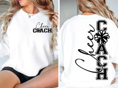 a woman sitting on top of a bed wearing a white shirt with the word coach printed on it