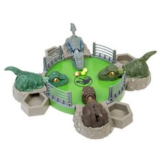 an animal park with two dinosaurs and a man sitting at the table in front of it