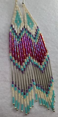 The multi colored bugle bead shines beautifully in the sun. These are approximately 5 3/4 inches in length, silver hooks. Bugle Beads, Jewelry Inspo, Diy Earrings, Aurora, Beading Patterns, Beaded Earrings