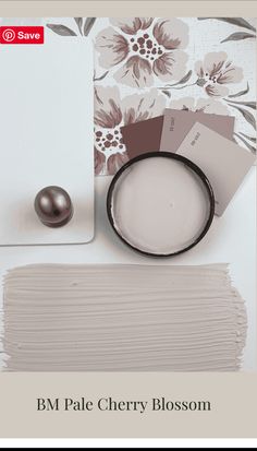 the bm pale cherry blossom paint swatch is next to a white plate with a brown ball on it