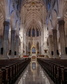 the inside of a large cathedral with pews