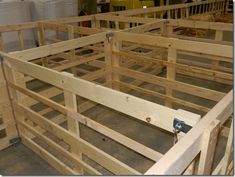 several wooden stalls are being constructed in a warehouse