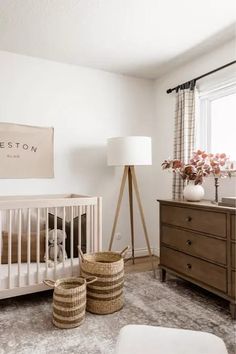 a baby's room with two baskets on the floor and a crib next to it