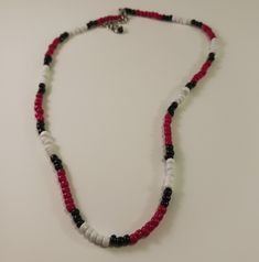 This is a seed bead necklace made in the Southwest style.  The colors are red, black and white.  The necklace is 18 1/2 inches in length and has a 2-inch extension chain. Hippy style necklace. Casual Red Beaded Necklace, Black Necklaces With Round Letter Beads, Black Beaded Necklace With Letter Beads, Black Beaded Necklace With Letter And Round Beads, Red Beaded Necklaces With Letter Beads, Casual Red Round Beaded Necklaces, Casual Red Tiny Beads Necklace, Red Beaded Necklace With Letter Beads, Casual Red Beaded Necklace With Tiny Beads