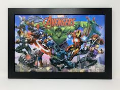 the avengerss are all together in this black framed artwork print by artist mark taylor