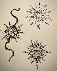 three sun and eye tattoos on white paper