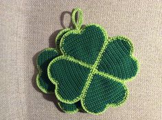 a crocheted shamrock ornament hanging from a hook