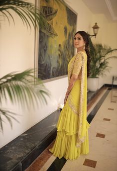 A two-piece mustard saree set from the Priti Sahni collection. This gorgeous mustard georgette pre-stitched ruffled saree with pearl and zardozi rose gold hand embroidery and scalloped edging is paired with a mustard net embroidered tie up blouse. Brown Sofas, Ruffled Saree, Tie Up Blouse, Saree For Wedding Function, Indian Bridesmaid Dresses, Haldi Outfits, Half Saree Lehenga, Zardozi Work, Embroidered Tie