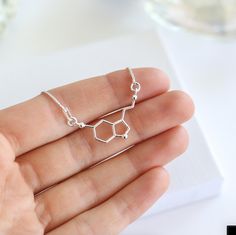 ✨ Sterling Silver Serotonin Bracelet - A Symbol of Happiness & Joy ✨ This elegant Serotonin Necklace is the perfect gift for someone special who loves science, chemistry, or simply spreading positivity. Featuring the serotonin molecule, this bracelet represents happiness and well-being, making it a meaningful and stylish accessory for everyday wear. Its minimalist design in 925 sterling silver ensures it pairs effortlessly with any casual outfit, adding a touch of personality to their style. Eac Molecule Jewelry, Serotonin Necklace, Bespoke Packaging, Running Necklace, Serotonin Molecule, Soul Sisters Gifts, Science Jewelry, Woman Logo, Bff Necklaces