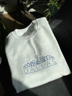 Embroidered Sweatshirt of Dallas Skyline !  The perfect gift or for personal use.  (For more examples, check out the Houston Skyline Sweater)  Personalize it by choosing the color of thread (:  If the color you want isn't listed - please reach out to see if I can find one you'll love. Please specify the color sweater you want in the notes or I will assume you want white ! If you have any questions before purchasing, please feel free to send a message ! Enjoy ! *As each order is customized, retur Houston Skyline, Dallas Skyline, Color Sweater, Embroidery Sweatshirt, Embroidered Sweatshirt, Embroidered Sweatshirts, Colorful Sweaters, Houston, Dallas