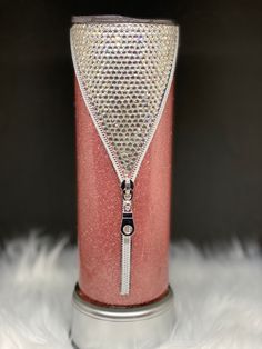 a pink and silver can with a zipper on it