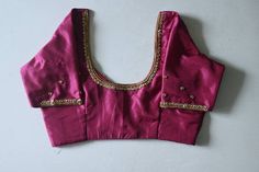 Beetroot pink kanchipuram silk blouse with beautiful hand emb (aari ) done with golden beads and stones. It can be customized to any colour and  size. Pl leave a msg for customization. Product colour may slightly vary due to photographic lighting sources or your device settings. For customization i will send you the measurement chart which you can fill and send it back to me . I ship to all places except germany. Standard shipment takes 30 working days  Speed takes 20 working days . Express takes 5 working days Art Silk Blouse With Gota Work For Wedding, Wedding Blouse With Gota Work In Art Silk, Dola Silk Blouse With Gota Work For Wedding, Wedding Blouse With Gota Work In Dola Silk, Silk Gota Work Blouse For Wedding, Silk Blouse With Gota Work For Wedding, Silk Wedding Blouse With Gota Work, Pink Silk Traditional Wear With Handwork, Pink Blouse Piece With Resham Embroidery In Katan Silk