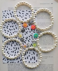 an open book with pearls and flowers on it