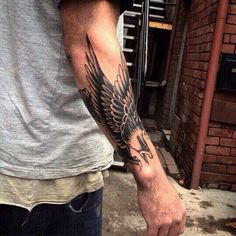 a man with a tattoo on his arm