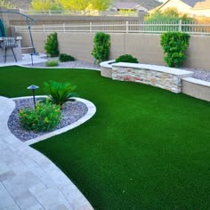 a backyard with artificial grass and landscaping