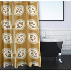 a bath tub sitting next to a shower curtain with circles on it's side