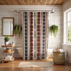 a bath room with a shower curtain and a rug on the floor in front of it