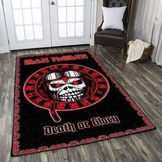 a black area rug with a red and white skull on the floor in front of a door