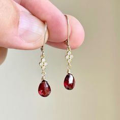 Garnet Earrings, January Birthstone, Red Teardrop Dangle Earrings, Minimalist Earrings Gold or Silver, Dainty Garnet Jewelry, Gift for women These precious delicate earrings feature vivid dark red garnet teardrops adorned with a white topaz connector in either gold filled or sterling silver. The earrings are suspended from lever back ear wires in the finish of your choice. These earrings are very feminine and subtle, perfect for every day. These make a perfect fall earring, or a gift for a women Gold And Red Earrings Dangle, Garnet Jewelry Earrings, Red Teardrop Earrings, Gold And Garnet Jewelry, Garnet Earrings Gold, Fall Inspired Jewelry, Gold Red Jewelry, Red And Gold Earrings, Red Dangle Earrings