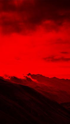 a red sky with mountains in the background