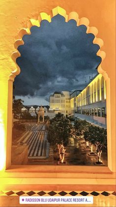 the view from inside an archway at night