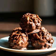 three chocolate covered donuts stacked on top of each other