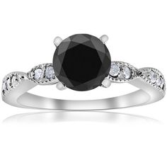 a black diamond engagement ring with white diamonds on the band and an oval center stone