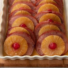 sliced pineapples and ham in a baking dish