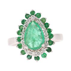 This Pear Cut Emerald ring has a 1.46 Carat Natural Emerald that measures at 7 mm x 9 mm. It is further embellished with 18 Emeralds that weigh 0.47 Carats and 18 Round Cut Diamonds that weigh 0.40 Carats. The total carat weight of the ring is 2.33 Carats. Curated in 18 Karat White Gold and weighs approximately 5.6 grams This ring is a size of 7 and can be re-sized at no additional charge. Pear-shaped Brilliant Cut Emerald Ring In White Gold, Luxury Pear-shaped Emerald Ring With Prong Setting, Formal Pear-shaped Emerald Ring In White Gold, Gia Certified Platinum Teardrop Ring, Gia Certified Teardrop Platinum Ring, Gia Certified Pear-shaped Emerald Ring, Teardrop Emerald Ring With Diamonds, Fine Jewelry Teardrop Emerald Diamond Ring, Elegant Gia Certified Pear-shaped Ring